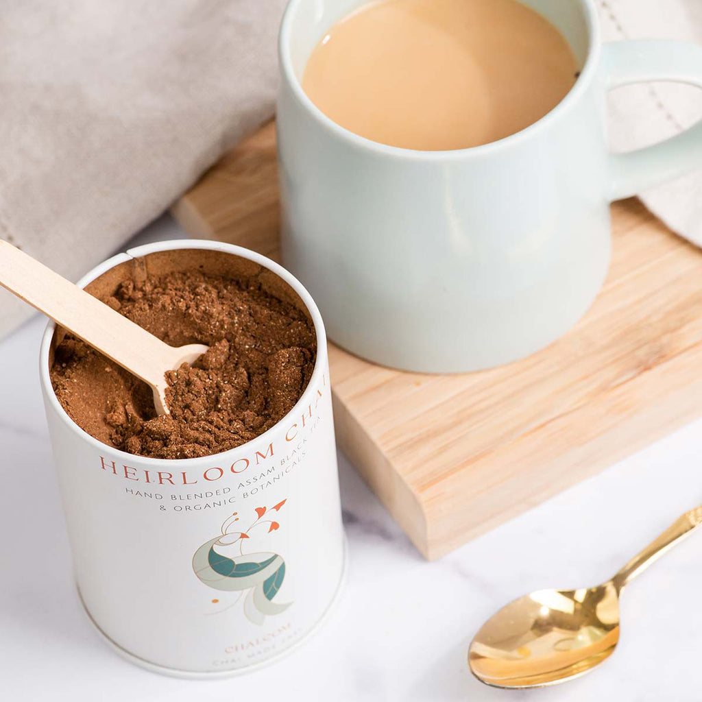 Heirloom Chai scoop with a cup of tea and spoon | Chai.com